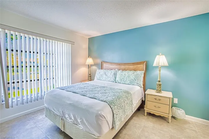 Bedroom featuring a textured ceiling and tile patterned flooring