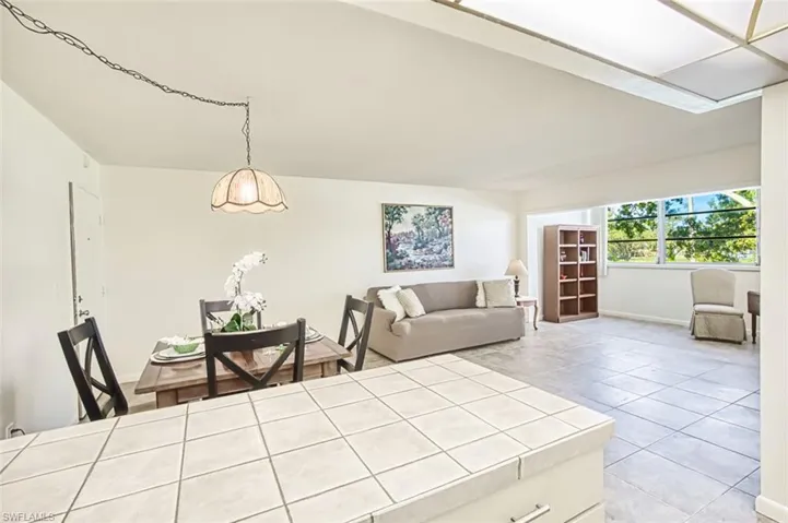 Living area with light tile patterned floors and baseboards