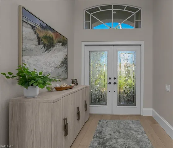 Elegant, yet informal foyer with custom leaded glass front doors.