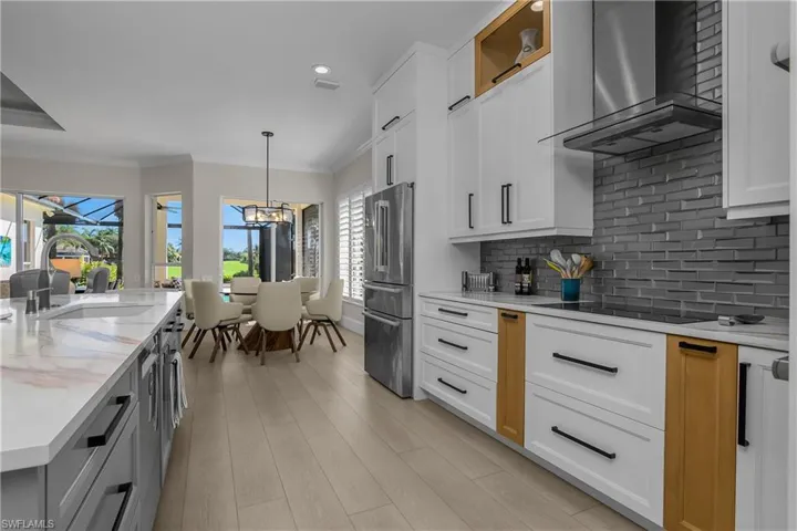 Kitchen walled backsplash is the very attractive 3-dimensional Subway Tile. Note modern kitchen ventilation system.