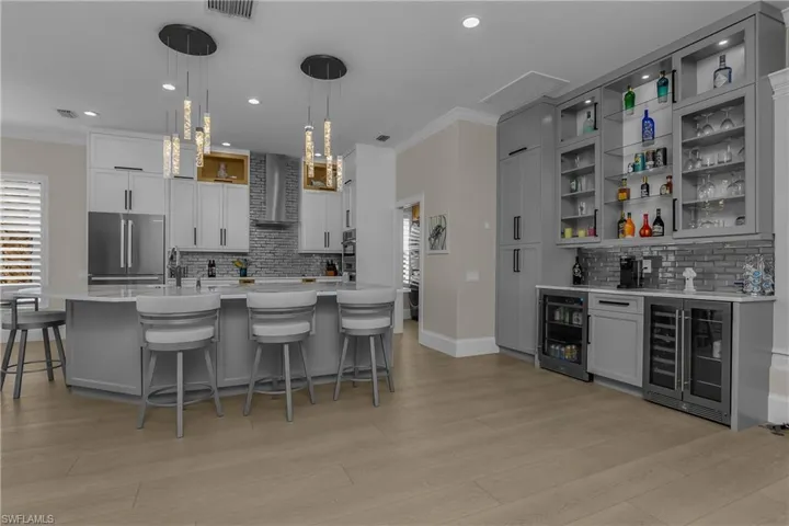 Bright and light...note 10 modern pendant lights above the island.