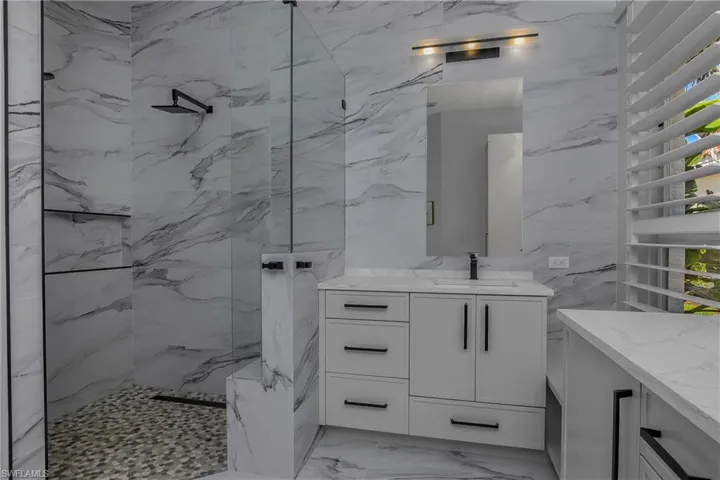 Extensive use of porcelain tile on master bath walls.