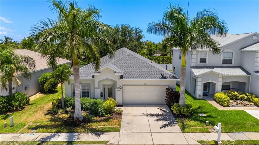 View of front of house featuring a garage and a front yard