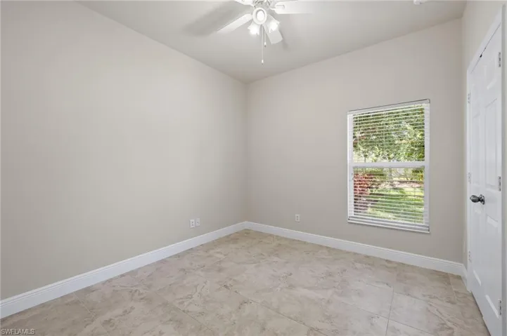 Spare room featuring ceiling fan and light tile floors
