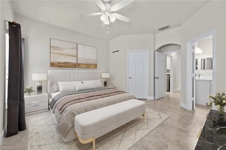 VS- Tiled bedroom featuring ceiling fan, ensuite bath, and sink
