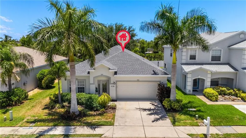 View of front of property with a garage and a front yard