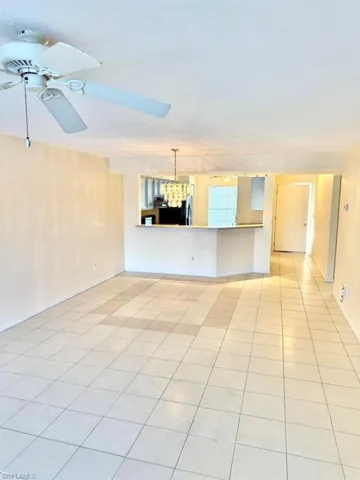 Unfurnished living room with a ceiling fan