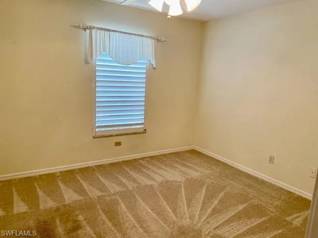 Unfurnished room with carpet and ceiling fan