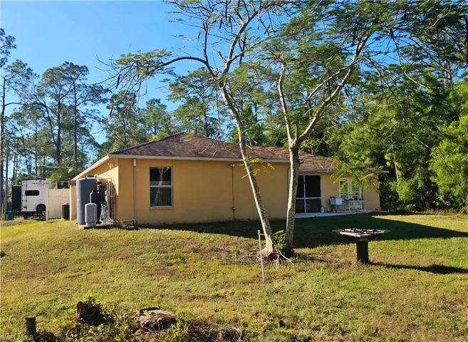 View of south side of home with a lawn