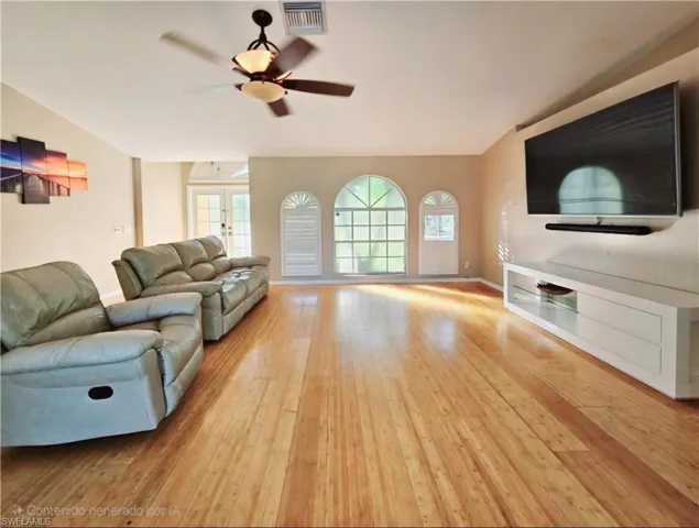 Living room with french doors, light wood-type flooring, and ceiling fan