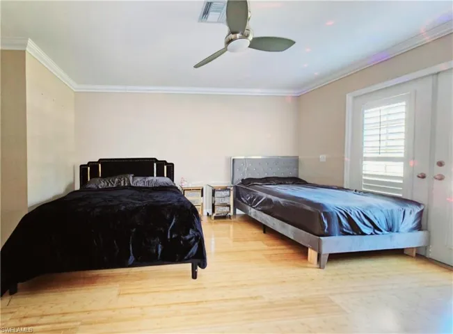 Master Bedroom featuring ceiling fan, ornamental molding, and light hardwood / wood-style flooring