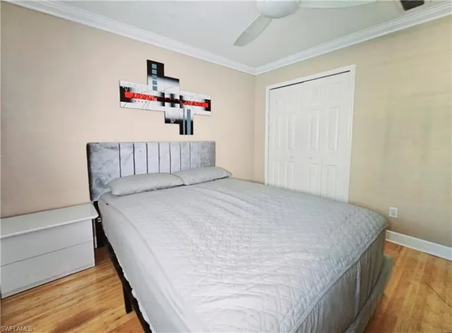 Third Bedroom with ceiling fan, wood-type flooring, ornamental molding, and a closet