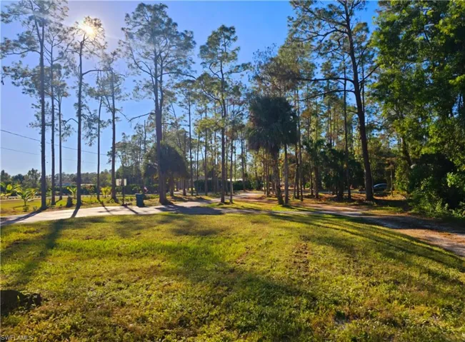 View of property's community with a yard