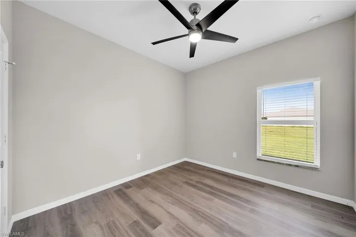 Spare room featuring ceiling fan and wood-type flooring