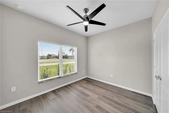 Unfurnished room featuring hardwood / wood-style floors and ceiling fan