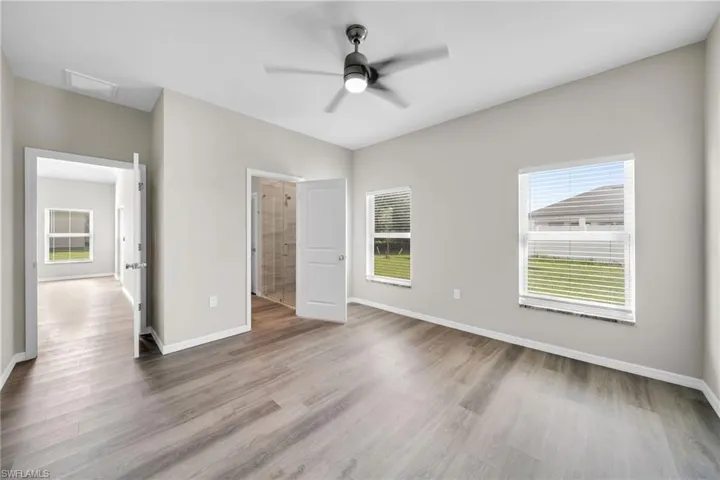 Unfurnished bedroom featuring ceiling fan and hardwood / wood-style flooring