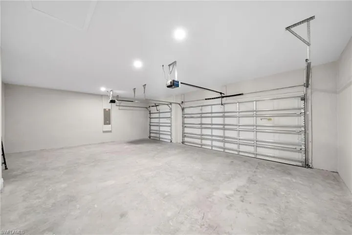 Garage with electric panel and a garage door opener