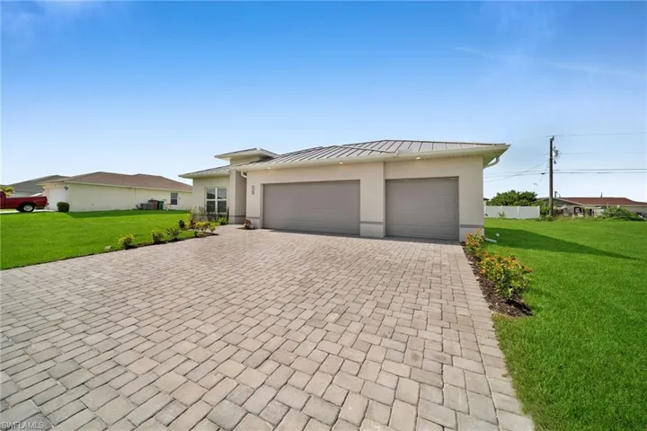 View of front of property with a garage and a front yard