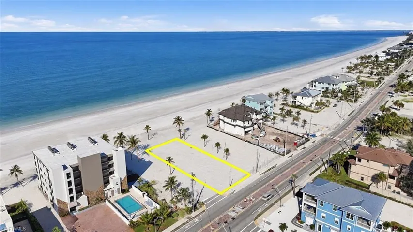 Beachfront parcel with extensive sandy frontage and palm trees - Virtually Edited Image