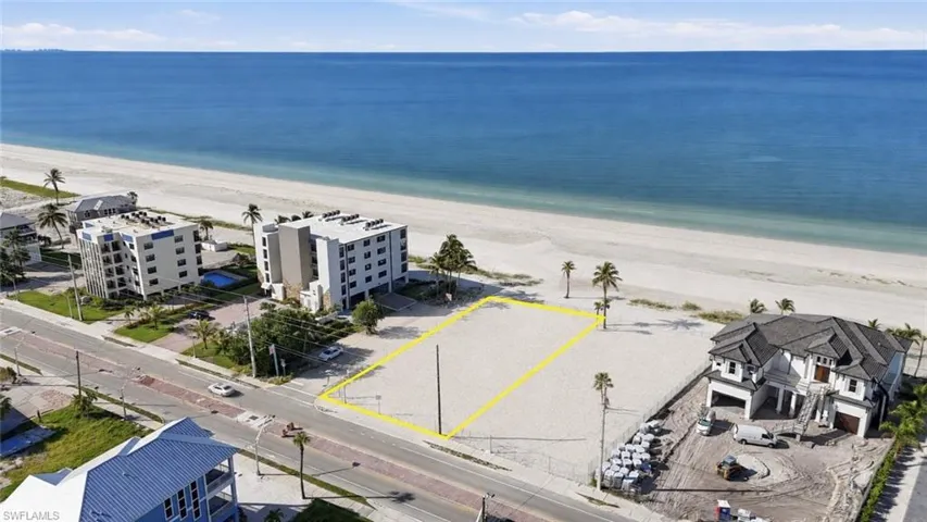 Expansive beachfront lot featuring a sandy terrain and direct access to the ocean - Virtually Edited Image