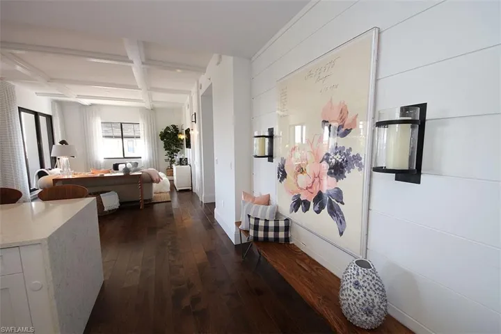 Hall with coffered ceiling, dark wood-style floors, and beamed ceiling