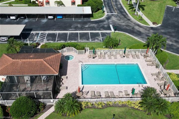 Community Pool with hot tub/jacuzzi - Dining and Dining/meeting area with BBQ area behind.