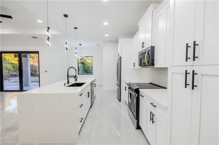 Kitchen featuring a sink, recessed lighting, a kitchen island with sink, and stainless steel appliances