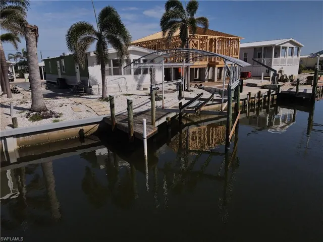 Dock area featuring boat lift and a water view