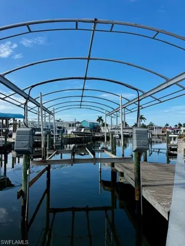 Dock area with boat lift and a water view