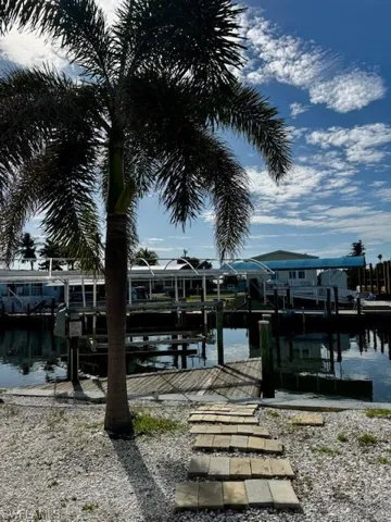 Dock area with a water view and boat lift