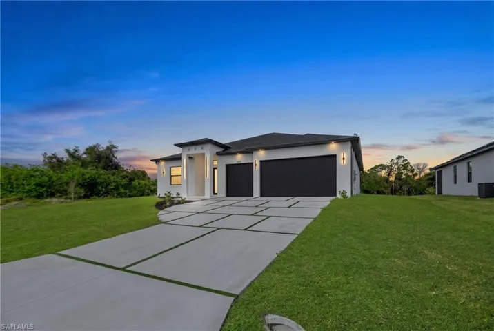 Contemporary single-story residence featuring a white stucco exterior and a dark roof