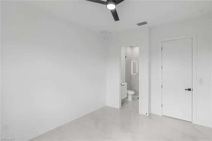 Room with white walls and large format tile flooring
