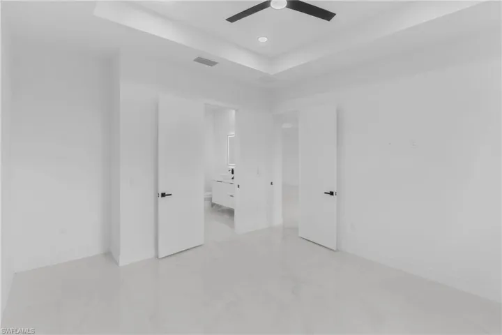 Bright interior room with white walls and large format tile flooring