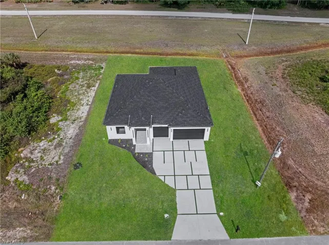Contemporary single-story residence featuring a dark shingle roof and light-colored exterior