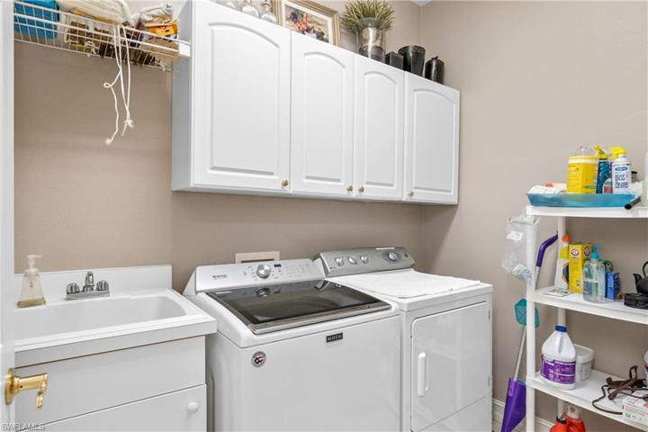 Laundry room w tub and cabinets