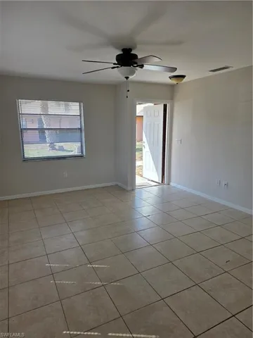 Unfurnished room featuring ceiling fan and light tile patterned floors