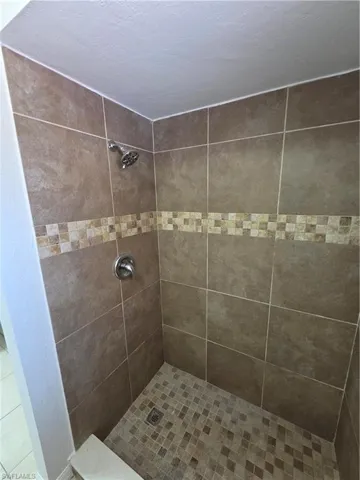 Full bathroom featuring a shower stall