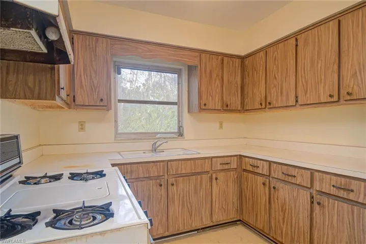 Kitchen with sink and white gas stove