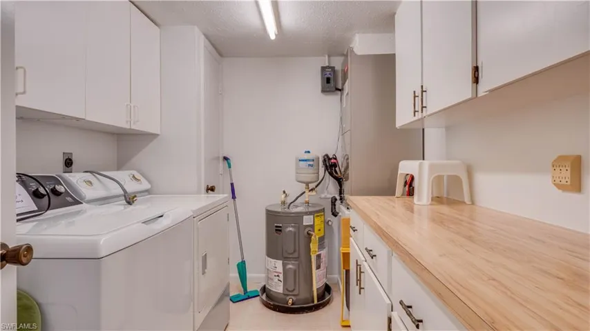 Inside laundry room with counterspace and storage