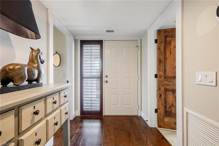 Foyer entrance with dark wood flooring