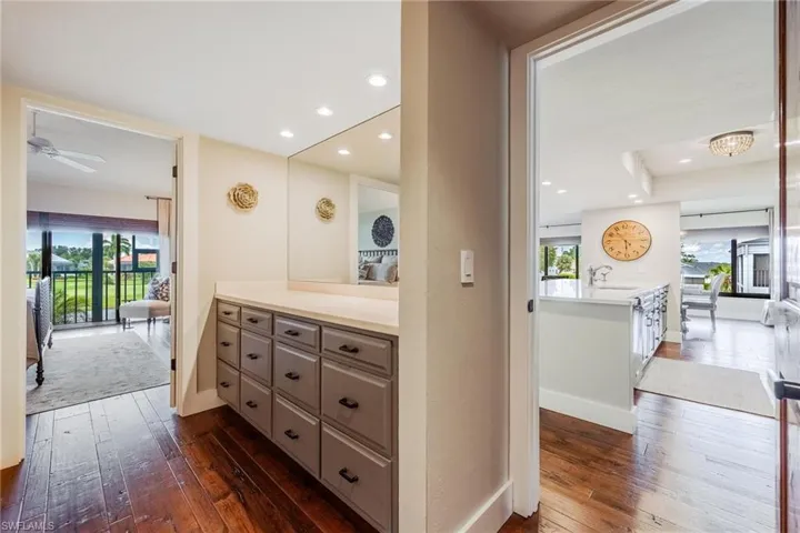 Bathroom featuring ceiling fan, a healthy amount of sunlight, wood-type flooring, and sink