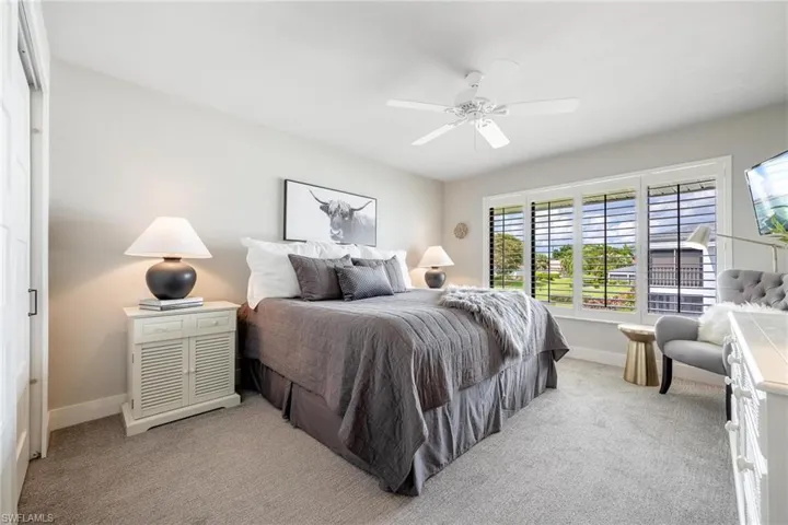 Bedroom featuring light colored carpet and ceiling fan