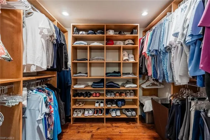 Spacious closet with dark hardwood floors