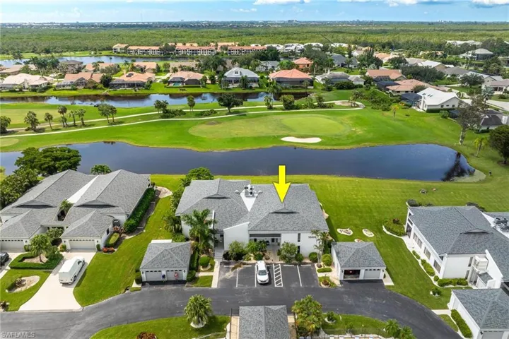 Birds eye view of property with a water view