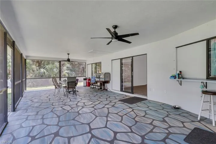 Huge enclosed lanai with a beautiful view of the pool area and lush landscaping. Access to master bedroom and both living areas.