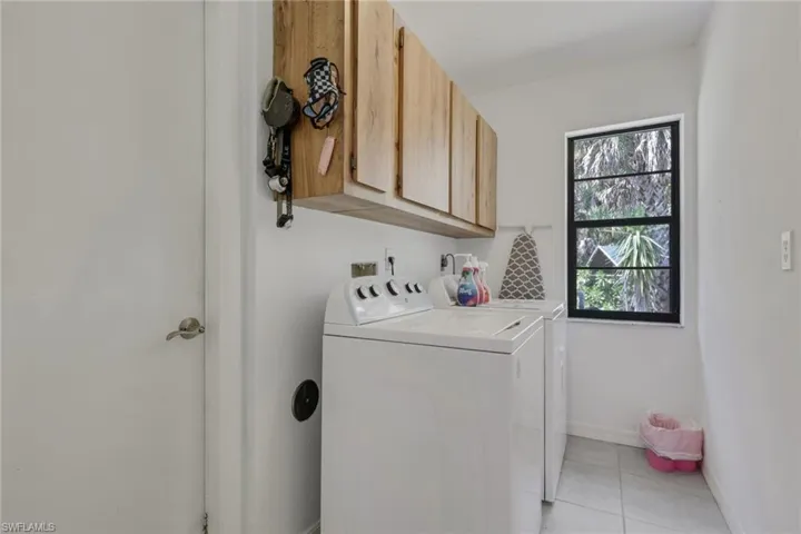 Laundry room with storage. Utility sink in the garage.