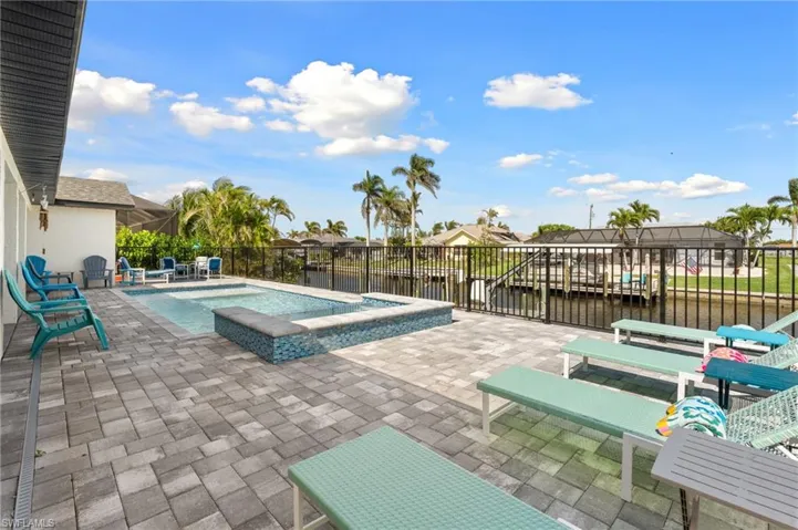View of swimming pool featuring a patio, a fenced in pool, and a water view