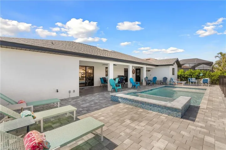 View of pool with a patio, an in ground hot tub, and fence