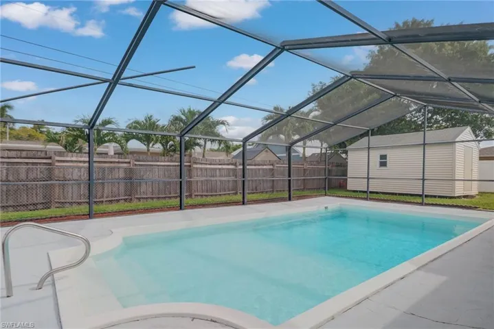 View of swimming pool with a lanai, a sunroom, and a fenced backyard