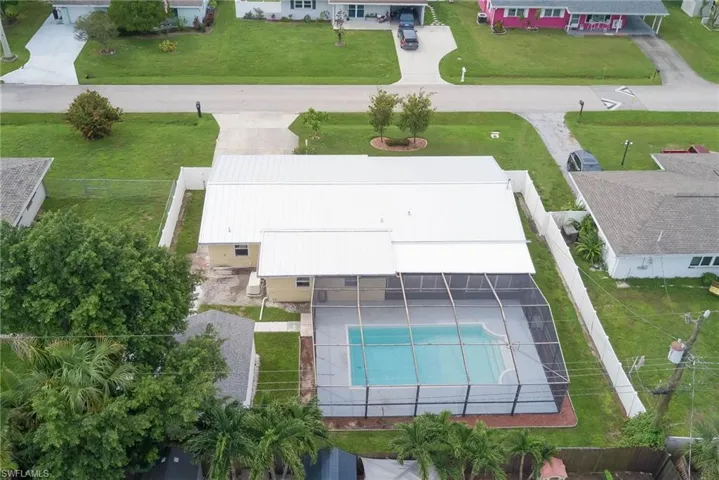 Aerial view of property and surrounding area featuring a pool